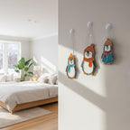 Bedroom window with hanging penguin stained glass decor glowing under sunlight, cozy handmade art.