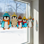 Close-up of penguin with brown hat and blue scarf, handmade stained glass winter home decoration.