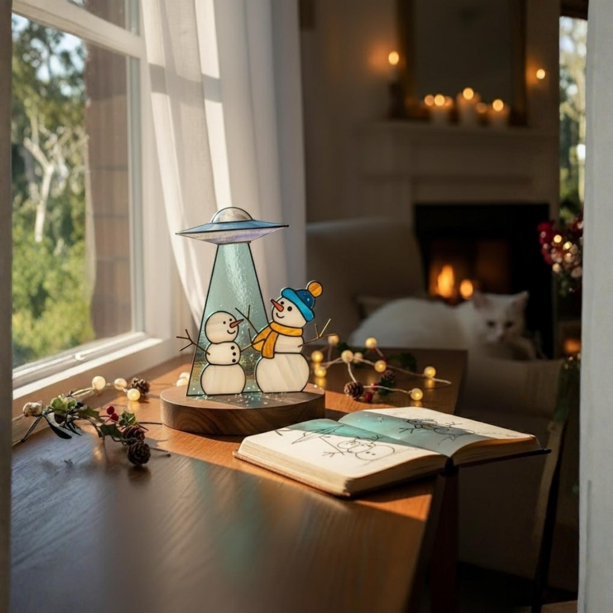 Handmade stained glass snowmen catching light by window – festive home decor piece.