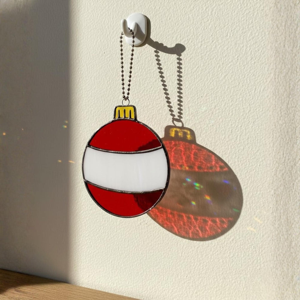 Red and white bauble stained glass ornament close up, Christmas tree décor