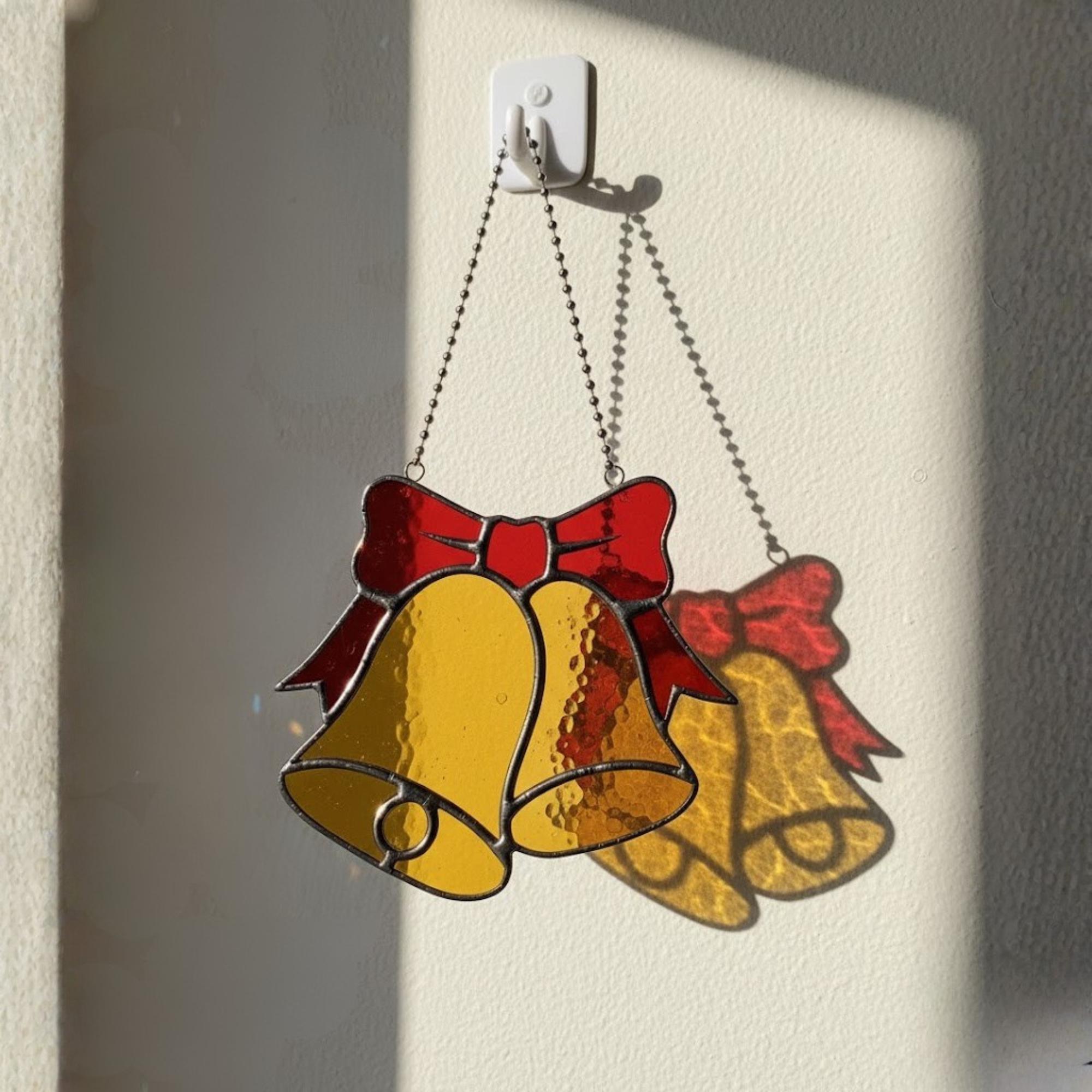 Golden bells with red bow stained glass ornament, classic holiday décor