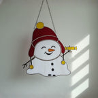 Smiling snowman glass ornament – cheerful handmade Christmas decoration.