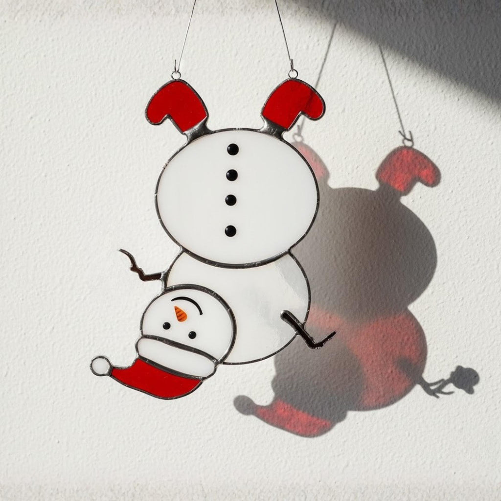 Mini snowman glass ornament hanging in sunlight – cute handmade holiday gift.