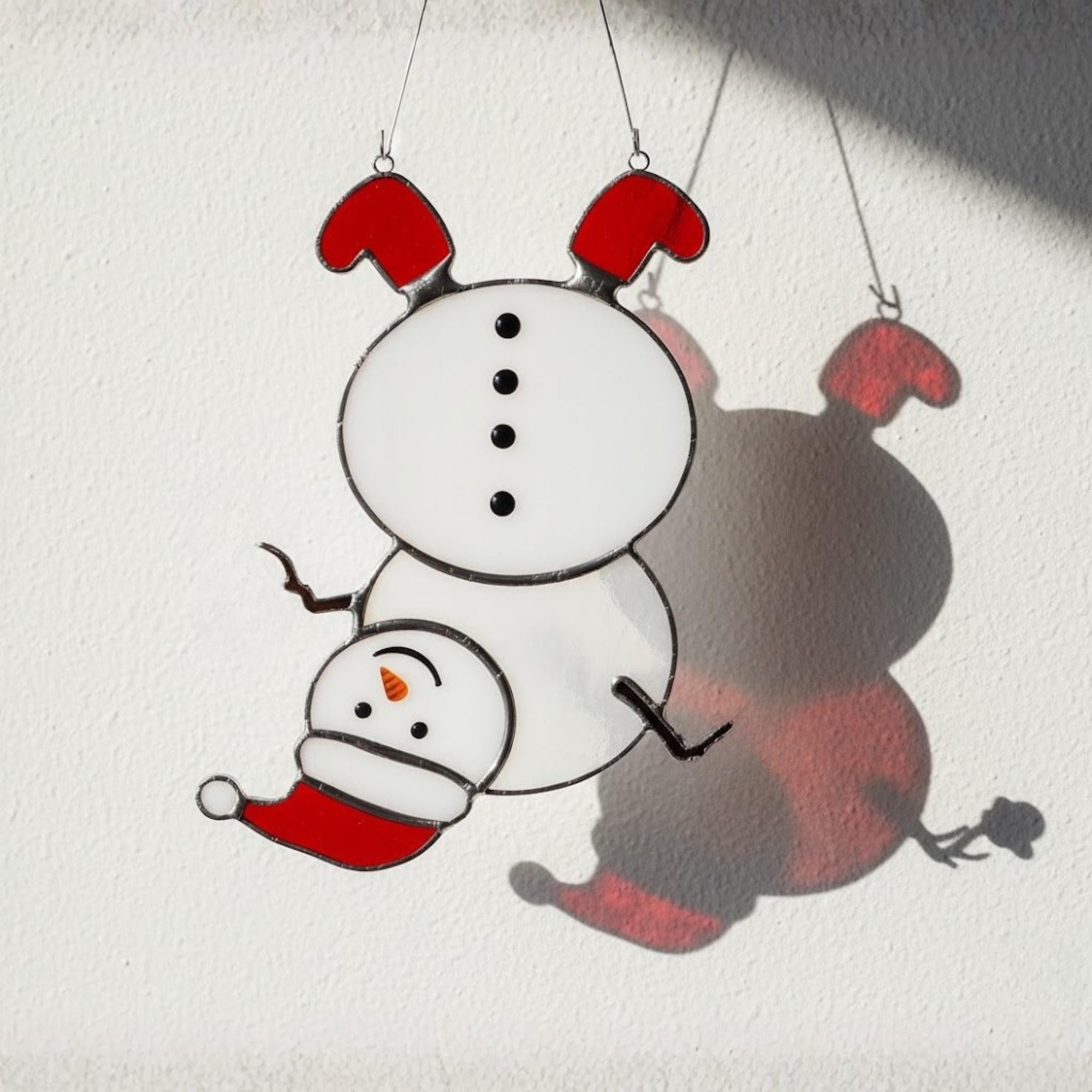 Mini snowman glass ornament hanging in sunlight – cute handmade holiday gift.