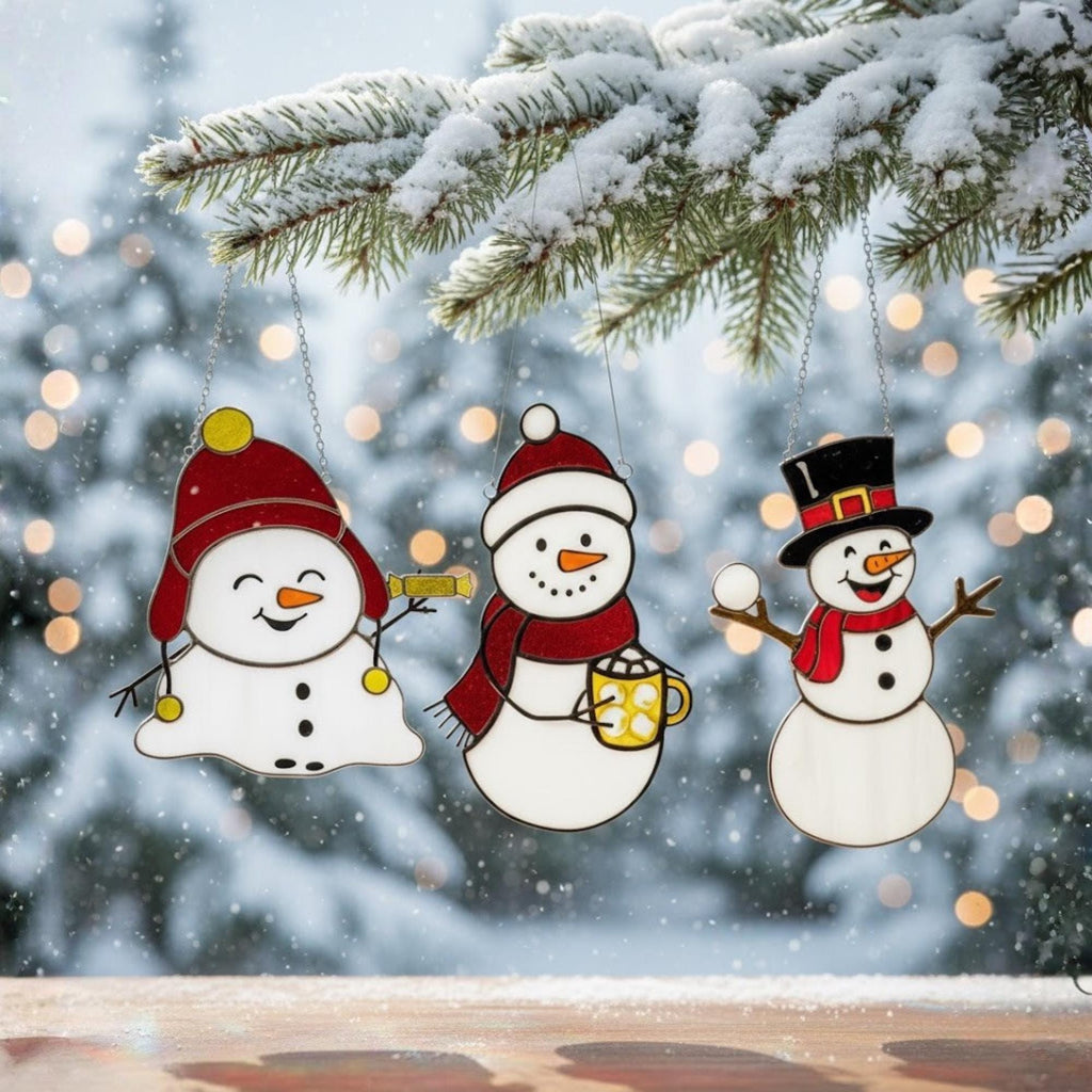 Handmade stained glass snowman ornaments on snow background – Christmas decor gift idea.