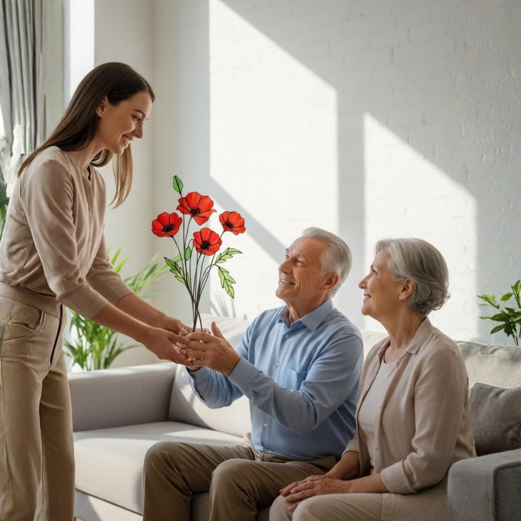 Woman gifting stained glass poppy bouquet to elderly couple, meaningful home gift