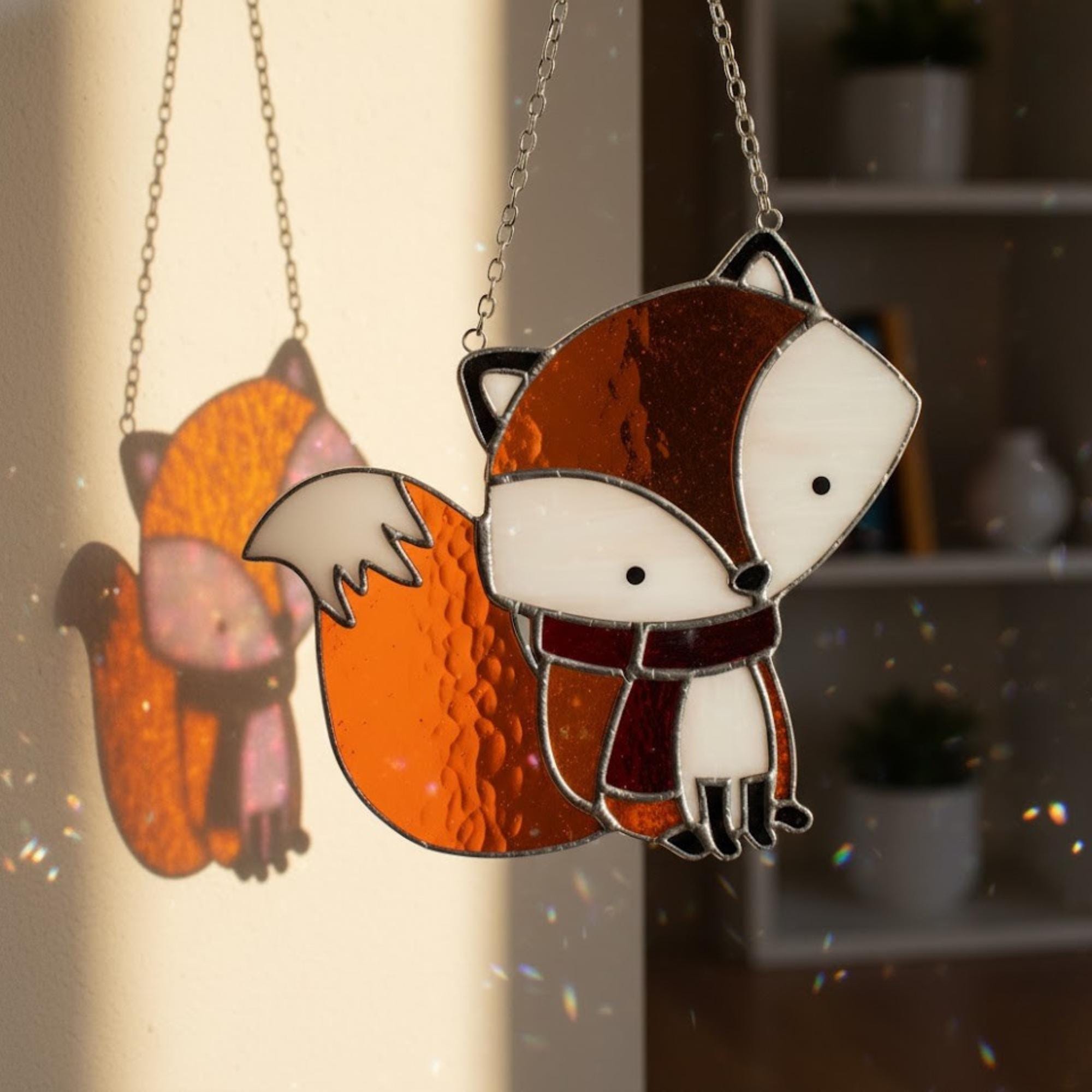 Cute stained glass fox ornament shining in afternoon light, window decoration