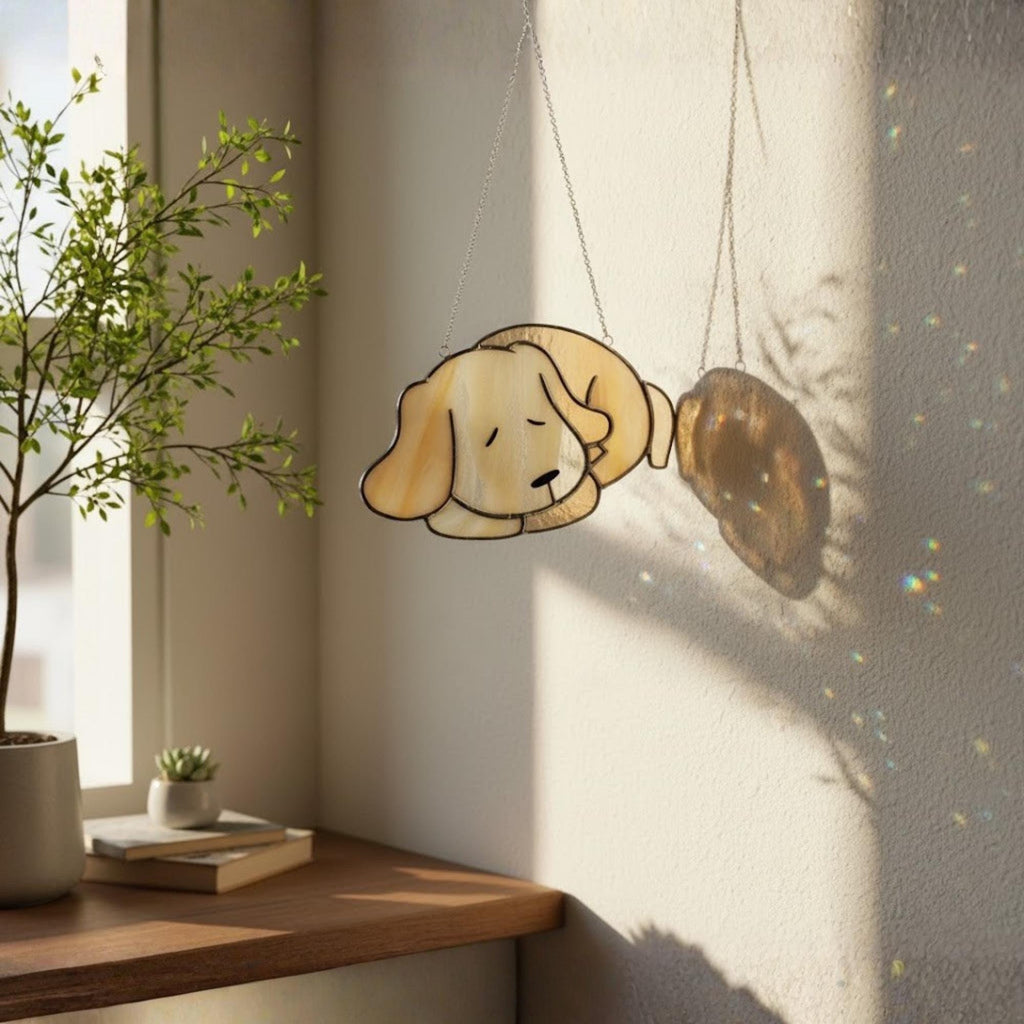 Handmade stained glass sleeping dog suncatcher glowing on window, pet memorial decor