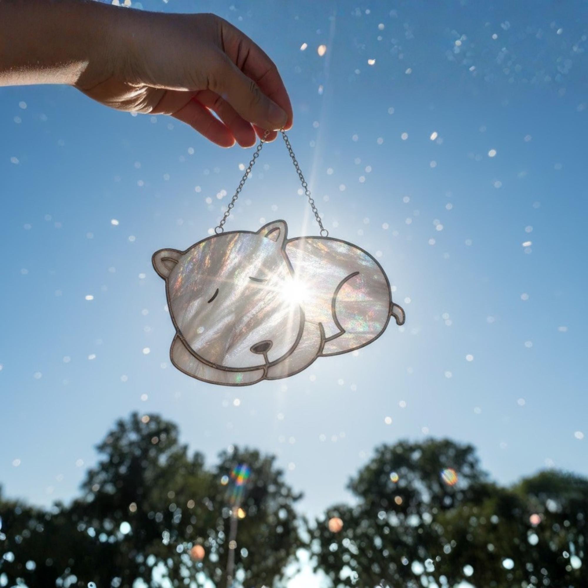 Brown sleeping dog stained glass ornament glowing in warm afternoon light