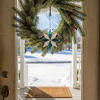 Stained glass snowflake wreath-style ornament on front door, holiday home decor