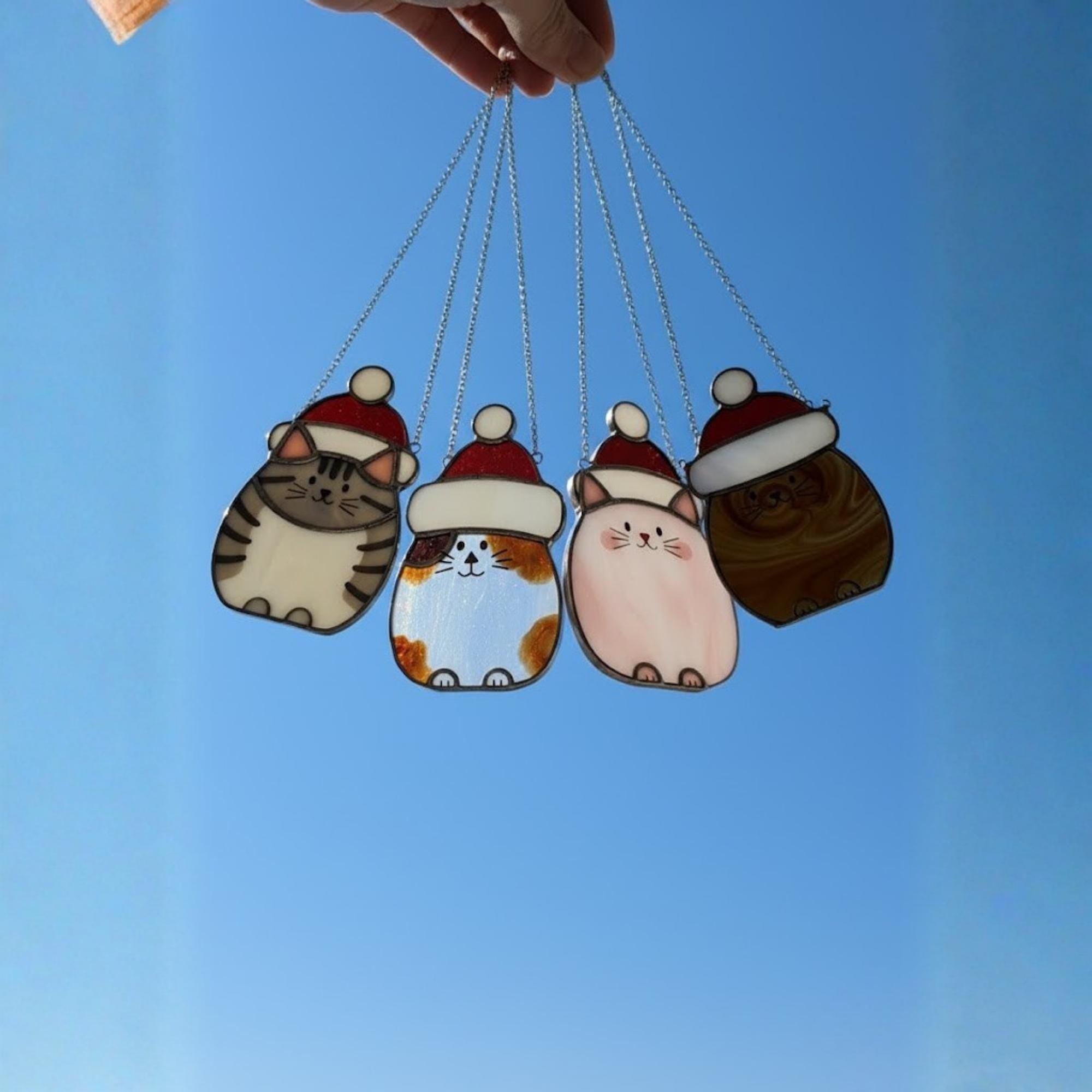 Cute calico cat stained glass ornament shining on window – perfect gift for pet lovers.