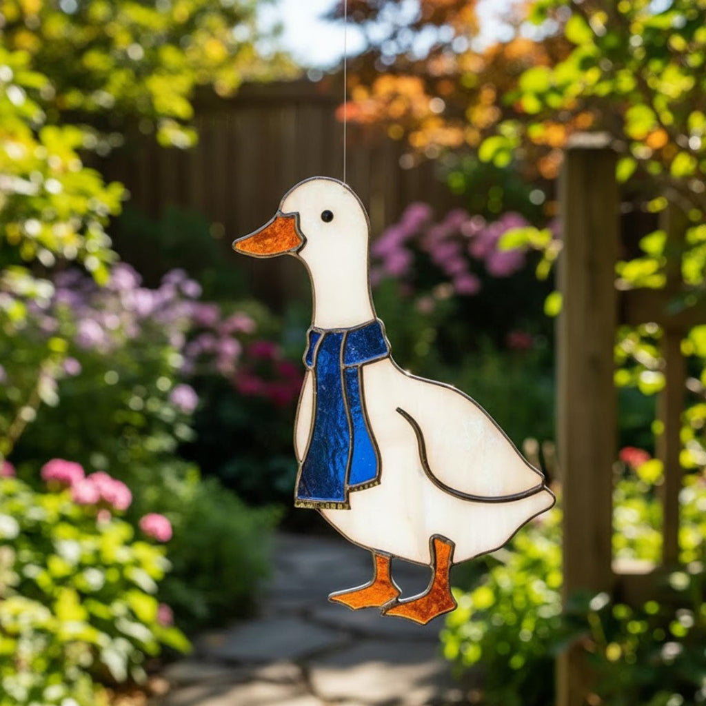 Blue-scarf goose stained glass suncatcher on windowsill, cottagecore bird decoration