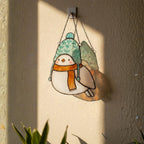 Handmade stained glass bird with green hat and orange scarf – Christmas window ornament.