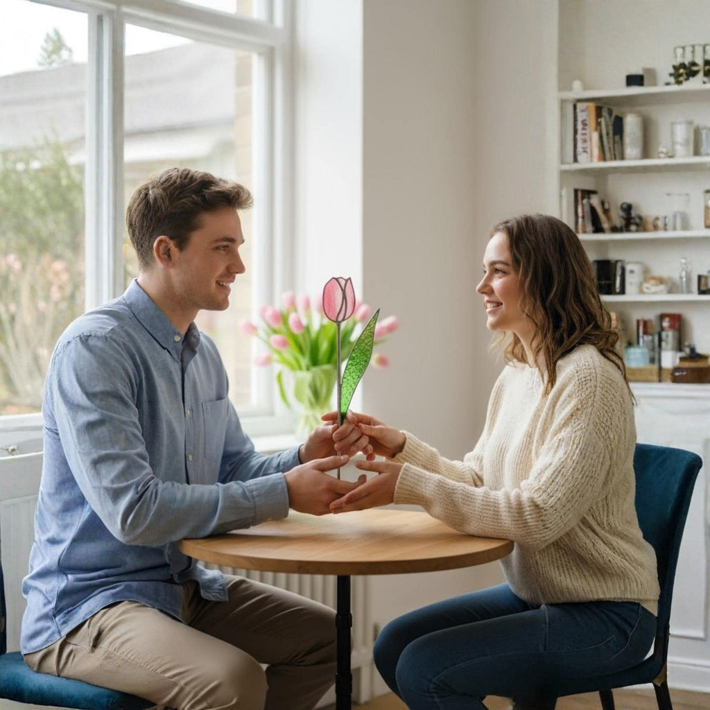 Couple exchanging a single pink stained glass tulip – romantic handmade gift for her.