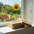 Three glass sunflowers in a vase reflecting sunlight – artistic floral decor.