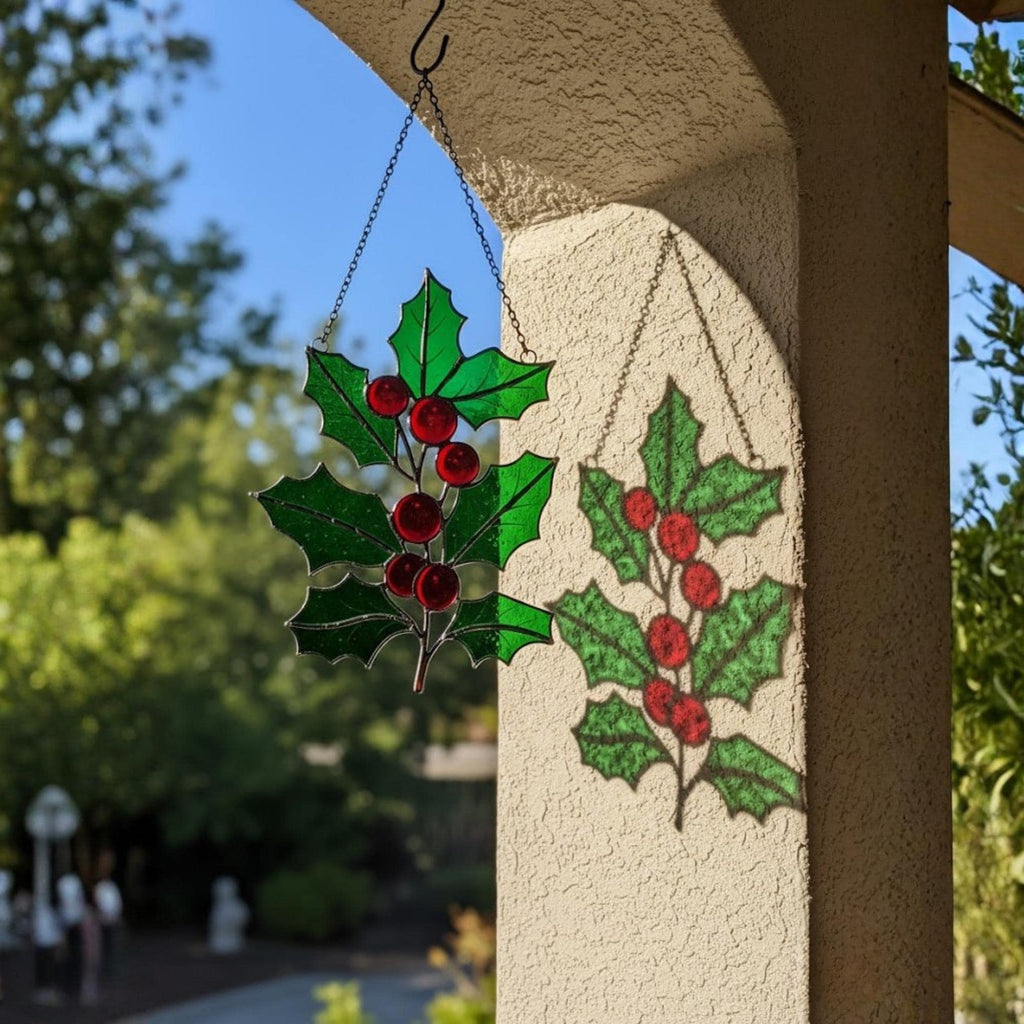 Handmade stained glass holly leaf ornament with red berries for Christmas decor.