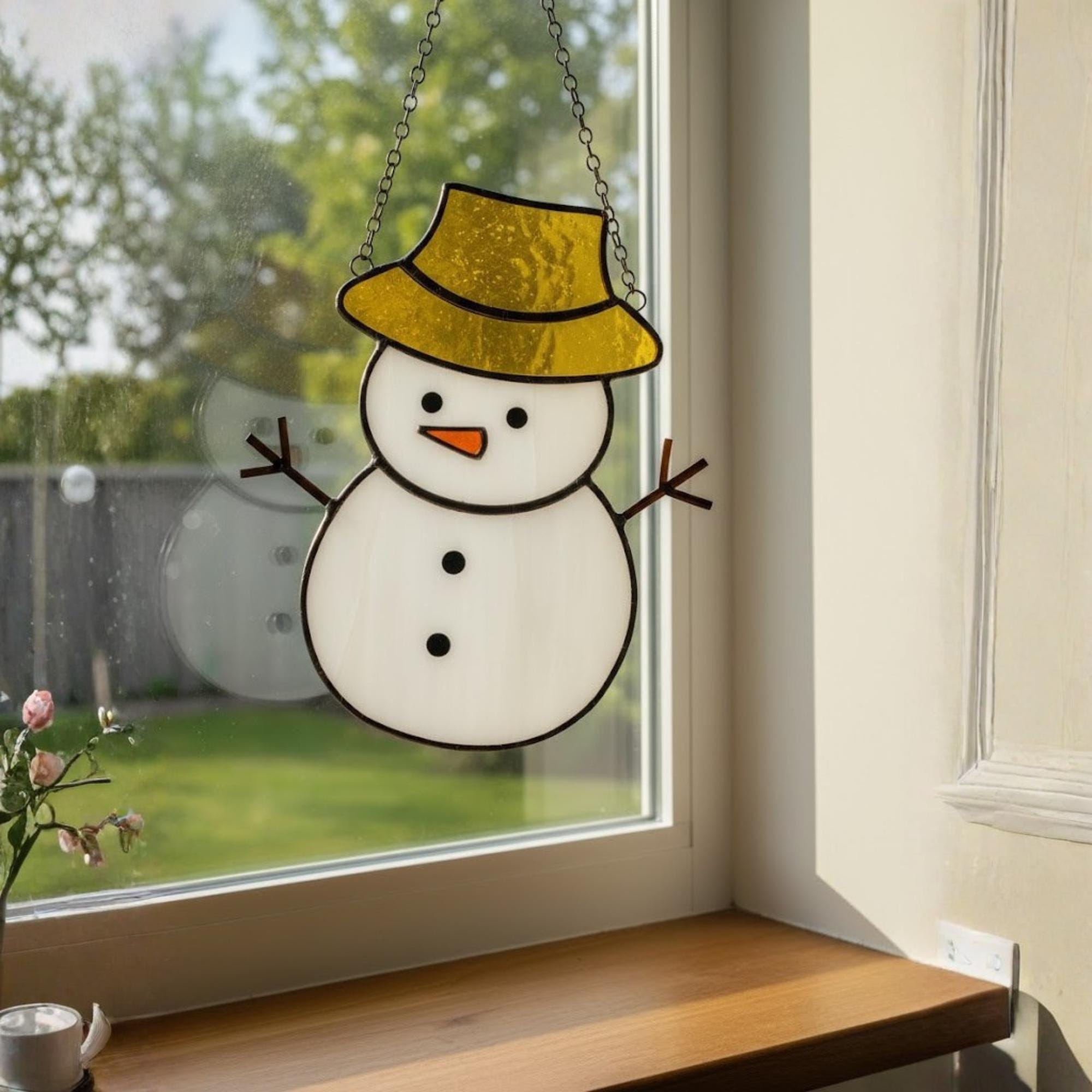 Christmas living room decor with stained glass snowman ornaments glowing warmly.