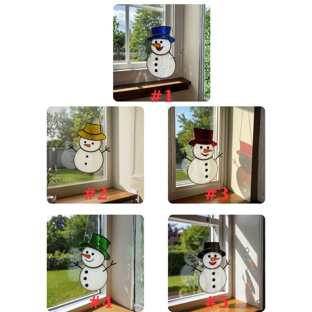 Black hat handmade glass snowman suncatcher glowing under bright sun.