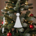Handmade glass angel displayed near window sill with sunlight shining through clear wings.