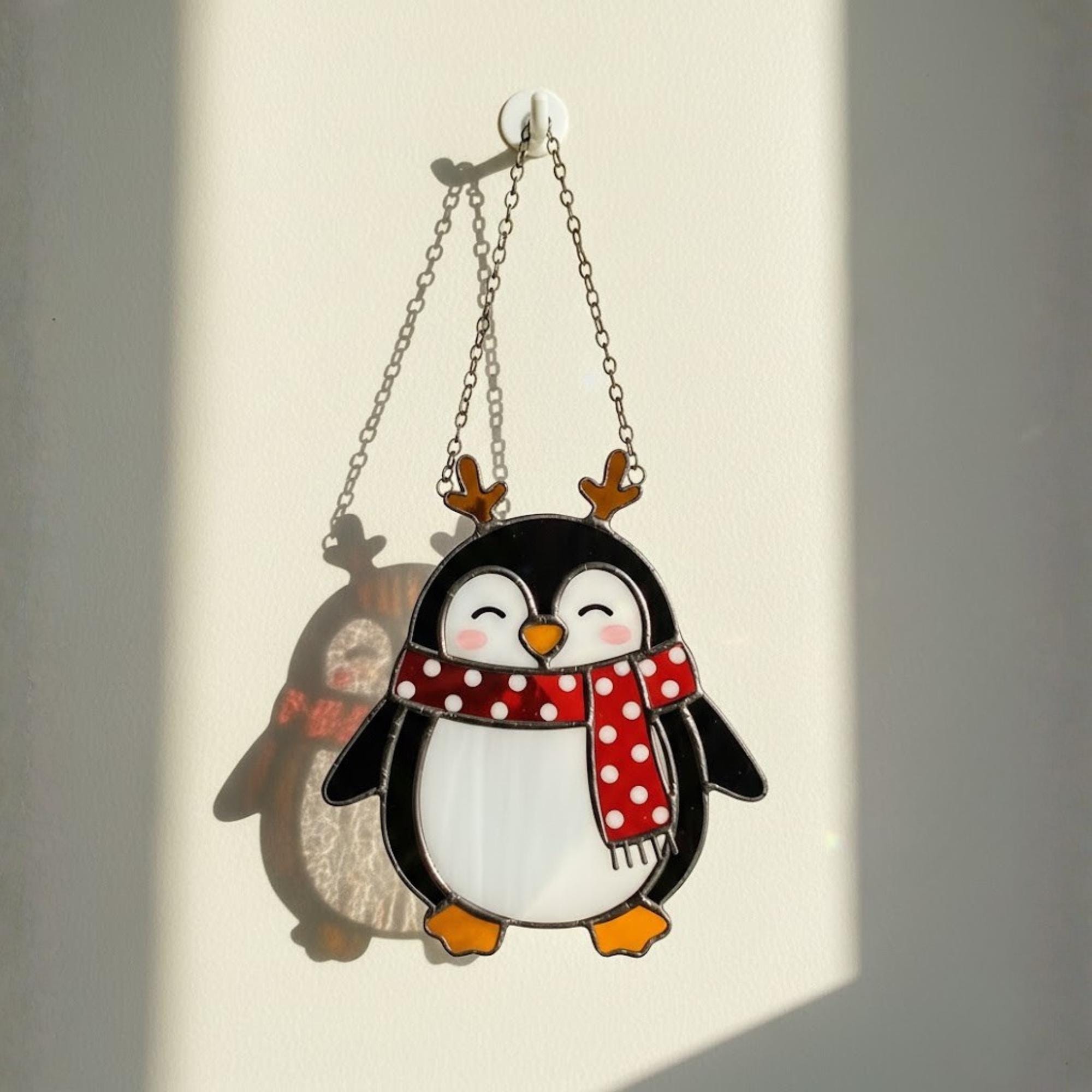Smiling penguin with striped scarf, cozy holiday window suncatcher