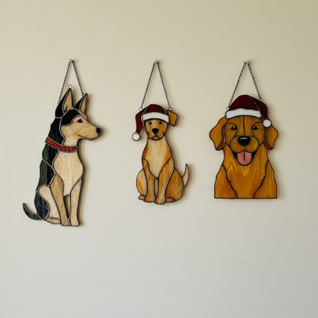 Stained glass dog ornament hanging outdoors among trees, handmade pet décor