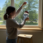 Three stained glass dog suncatchers displayed on wall, Christmas hat designs