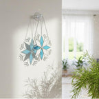 Handmade stained glass snowflake suncatcher glowing in window light, winter home decor