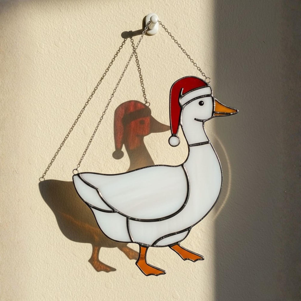 Classic white goose stained glass suncatcher hanging on sunny wall
