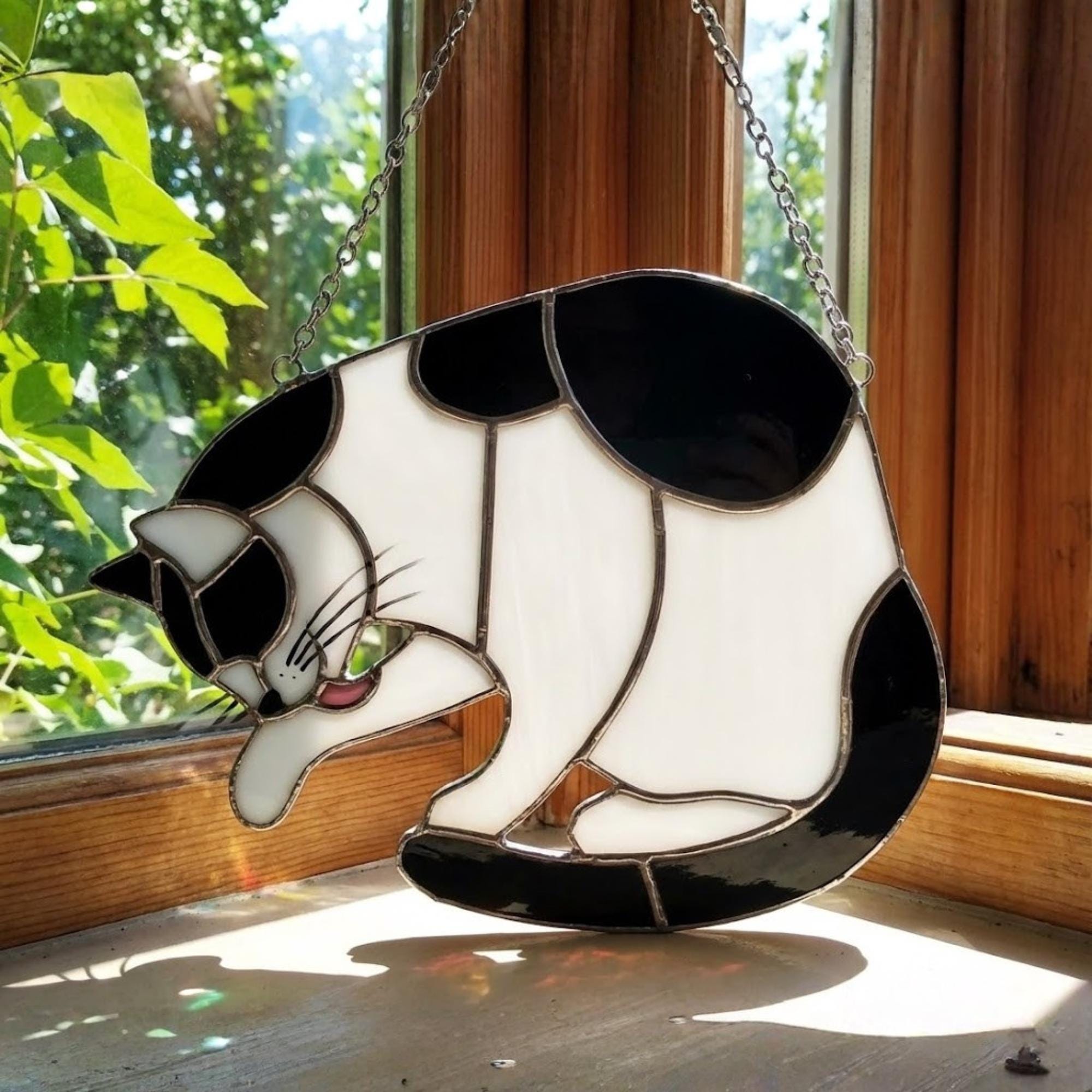 Stained glass Tuxedo cat suncatcher in black and white, available in funny lounging and sitting poses, window hanging or wood stand decor.