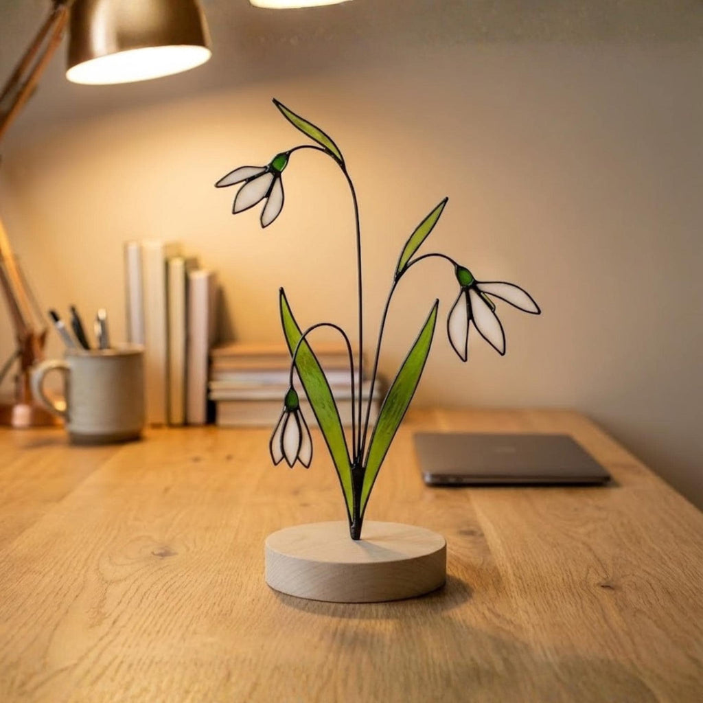 Stained glass snowdrop flower with white petals and green leaves, January birth month gift, available with personalized wood stand or as a single stem.