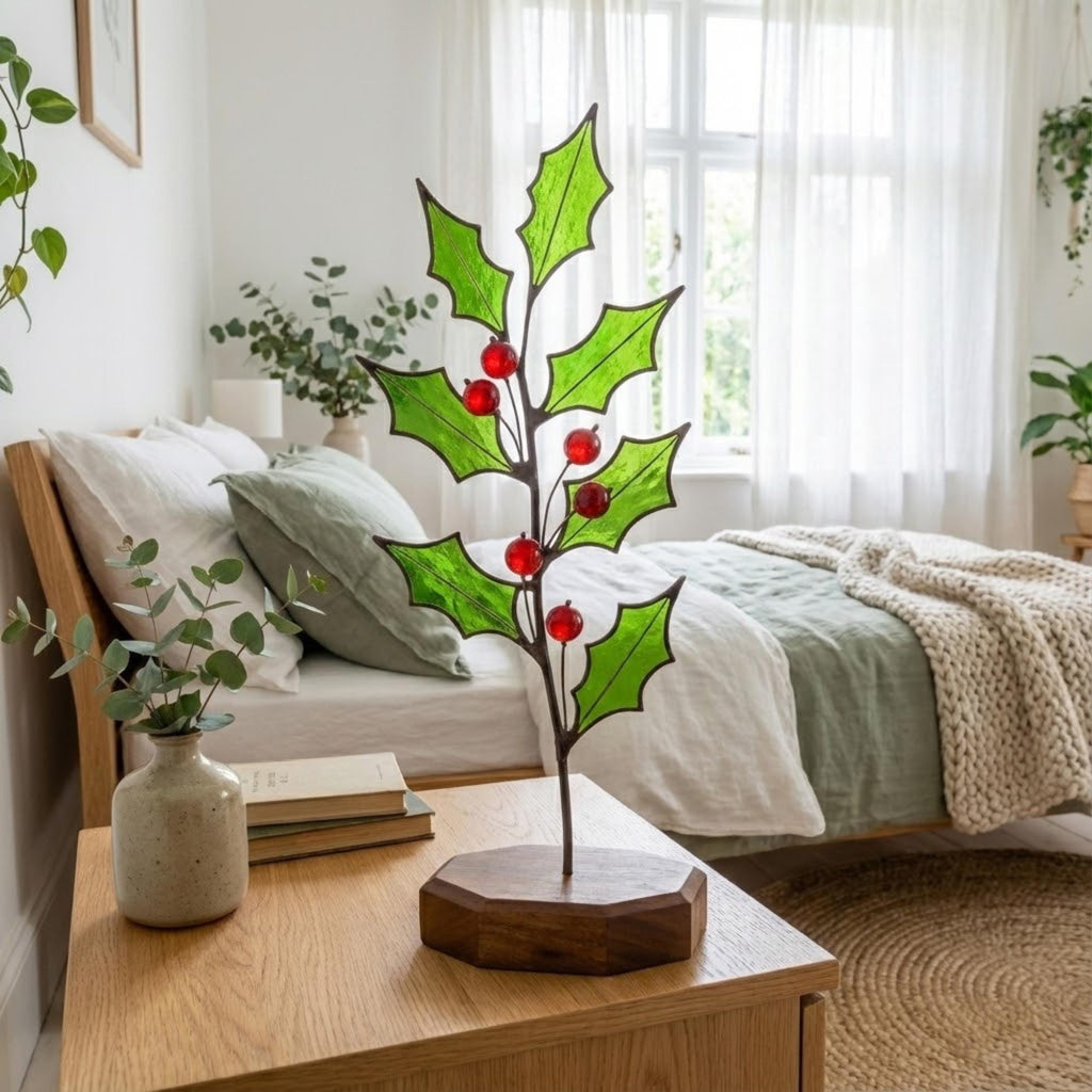 Stained glass holly branch with red berries on wooden base, cozy bedroom decor, Christmas table centerpiece.
