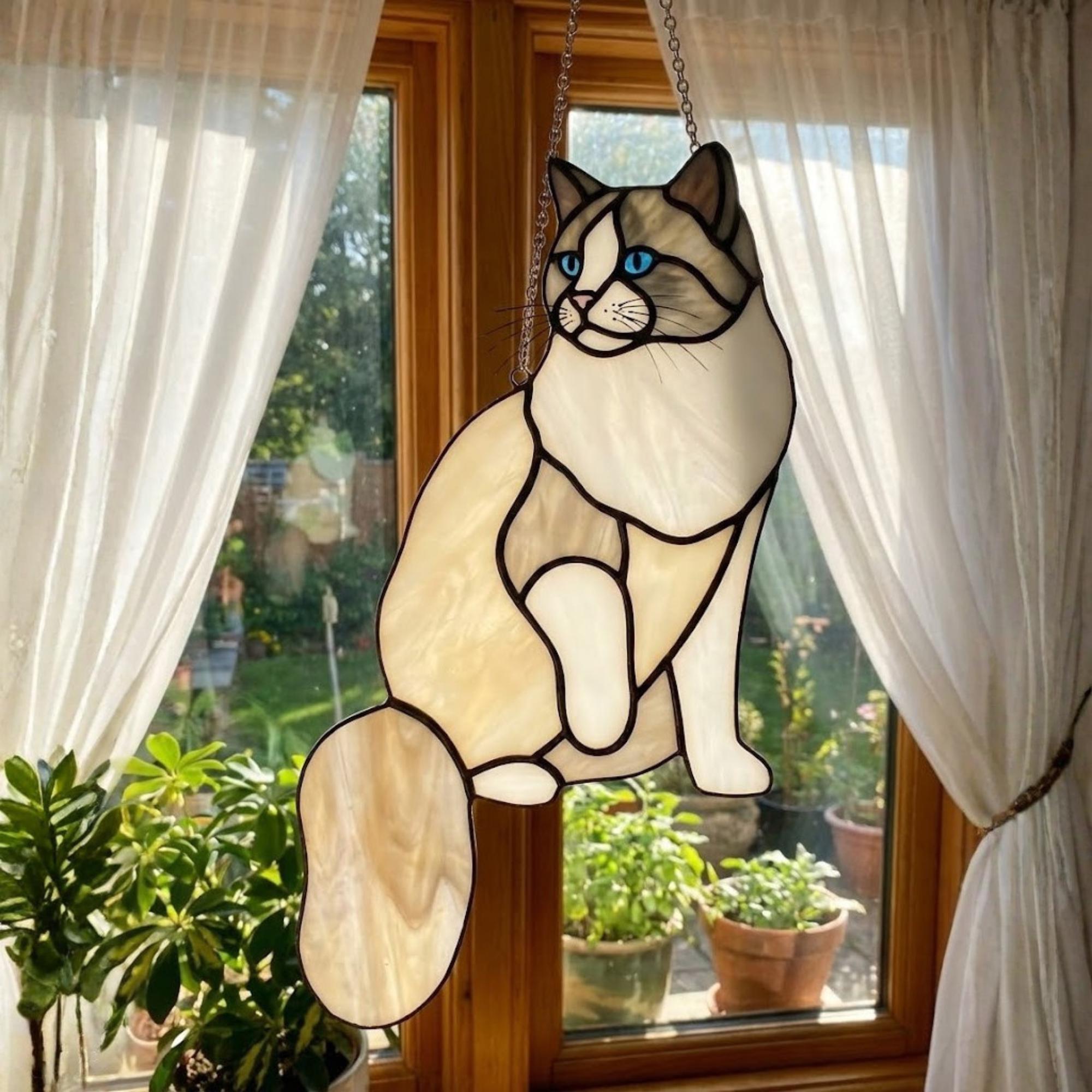 Sitting Siamese cat suncatcher with blue eyes, handmade glass art.