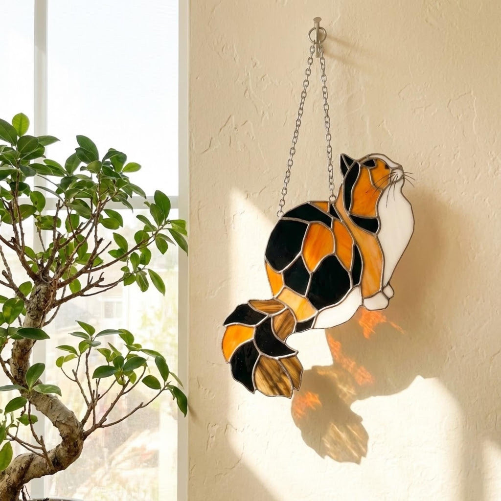 Stained glass Calico cat suncatcher with orange black and white patches, available in sitting and sleeping poses, window hanging or wood stand decor.