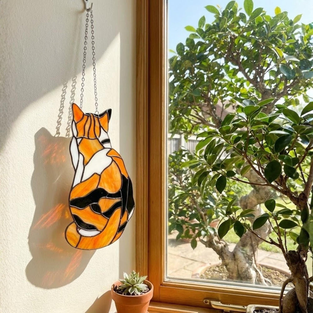 Stained glass Calico cat suncatcher with orange black and white patches, available in sitting and sleeping poses, window hanging or wood stand decor.