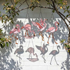 Pink stained glass flamingo suncatcher hanging in window casting vibrant colored shadows tropical beach house decor handmade gift for mom by LuzyGlassArt.
