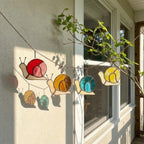 Cute stained glass snail suncatcher hanging on window, whimsical cottagecore decor for plant lovers, colorful glass animal art handmade in Vietnam, goblincore aesthetic gift.