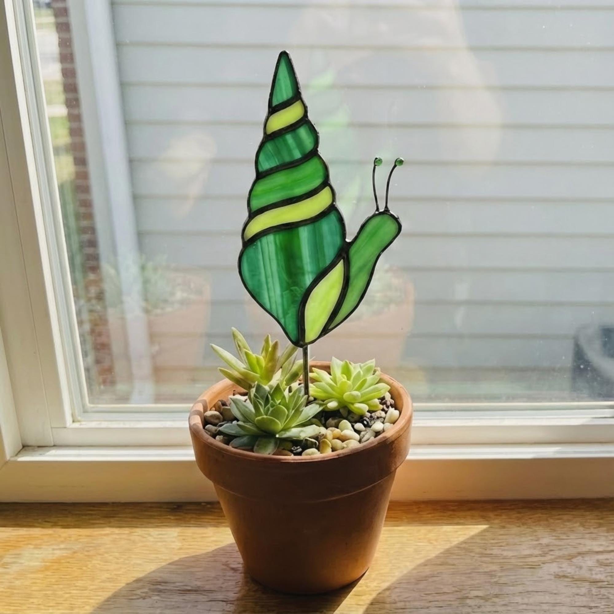 Cute stained glass snail suncatcher hanging on window, whimsical cottagecore decor for plant lovers, colorful glass animal art handmade in Vietnam, goblincore aesthetic gift.
