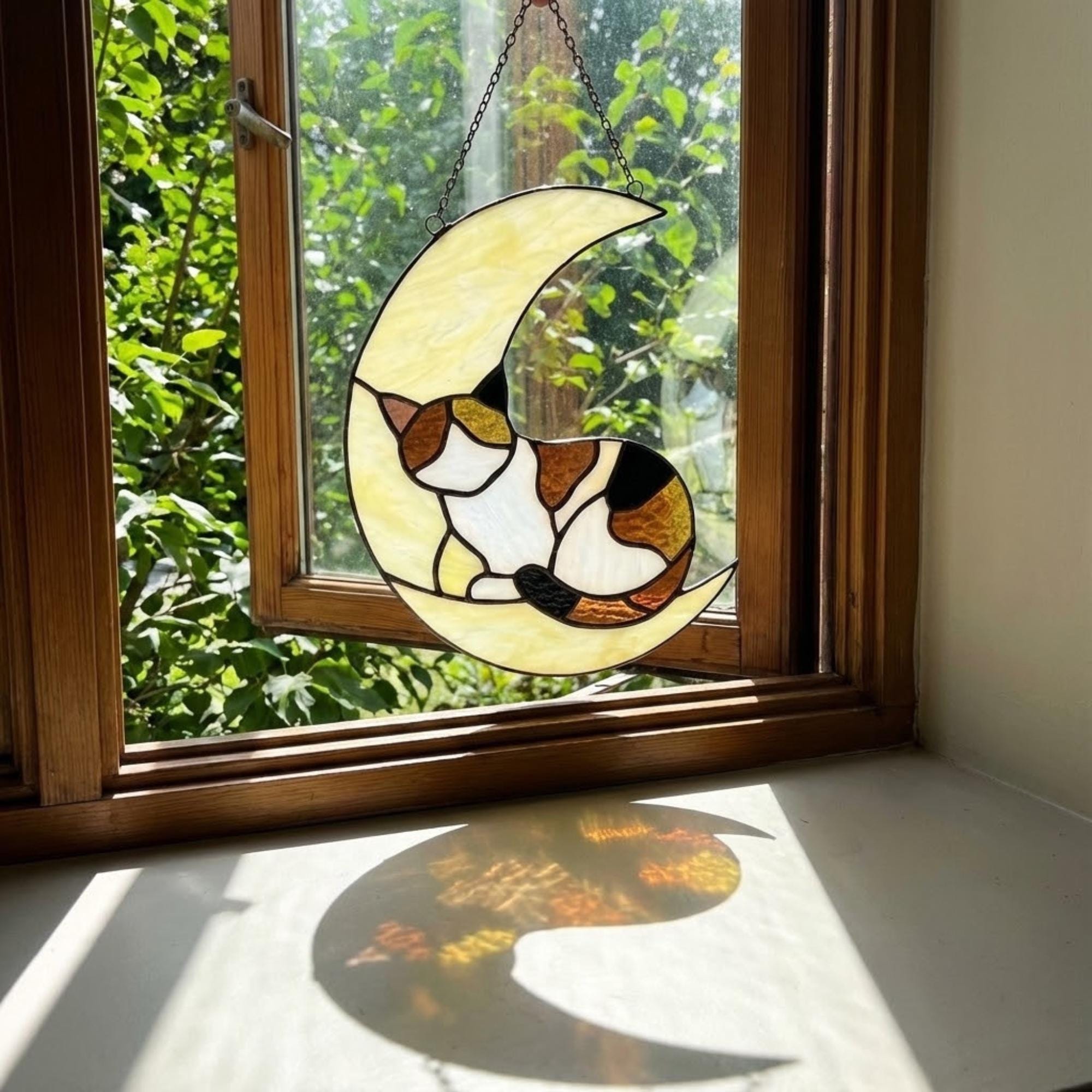 Stained glass sleeping cat on moon suncatcher window hanging, black orange tuxedo calico cat memorial gift for pet loss, handmade celestial decor by LuzyGlassArt.