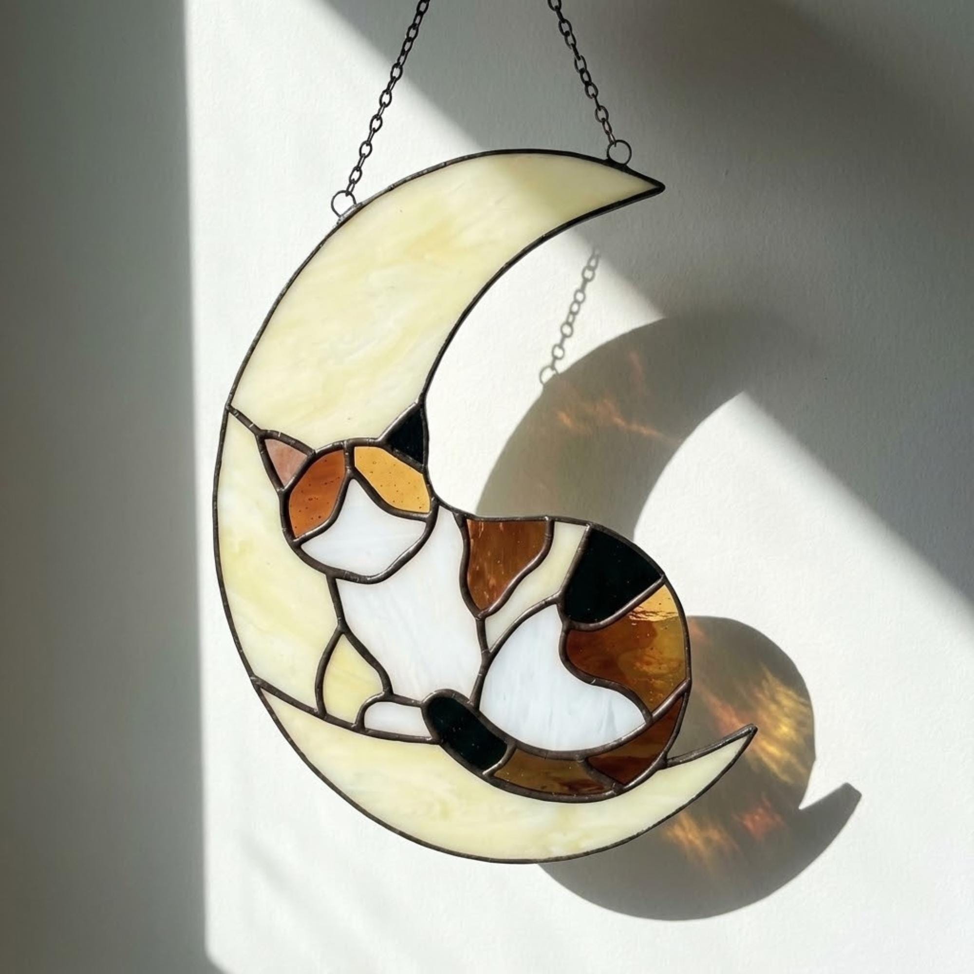 Stained glass sleeping cat on moon suncatcher window hanging, black orange tuxedo calico cat memorial gift for pet loss, handmade celestial decor by LuzyGlassArt.
