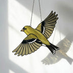 Stained glass American Goldfinch suncatcher hanging on window casting yellow shadows, vibrant yellow bird ornament for birdwatchers, handmade state bird gift for New Jersey Iowa Washington by LuzyGlassArt.
