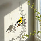 Stained glass American Goldfinch suncatcher hanging on window casting yellow shadows, vibrant yellow bird ornament for birdwatchers, handmade state bird gift for New Jersey Iowa Washington by LuzyGlassArt.