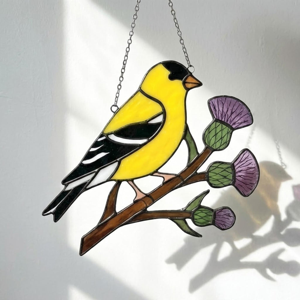 Stained glass American Goldfinch suncatcher hanging on window casting yellow shadows, vibrant yellow bird ornament for birdwatchers, handmade state bird gift for New Jersey Iowa Washington by LuzyGlassArt.