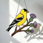 Stained glass American Goldfinch suncatcher hanging on window casting yellow shadows, vibrant yellow bird ornament for birdwatchers, handmade state bird gift for New Jersey Iowa Washington by LuzyGlassArt.