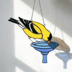 Stained glass American Goldfinch suncatcher hanging on window casting yellow shadows, vibrant yellow bird ornament for birdwatchers, handmade state bird gift for New Jersey Iowa Washington by LuzyGlassArt.