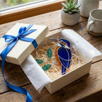 Vibrant stained glass Kingfisher bird suncatcher with blue wings and orange chest perched on a branch, displayed as window hanging or table decor.