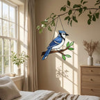 Stained glass Blue Jay bird suncatcher on branch hanging on window casting blue shadows, handmade realistic nature decor for birdwatchers by LuzyGlassArt.