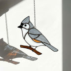 Stained glass Black-capped Chickadee bird suncatcher on branch hanging on window, handmade Maine and Massachusetts state bird gift, realistic nature decor by LuzyGlassArt.