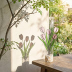 Pink stained glass tulip bouquet 3D flower stems held in hands as Mother's Day gift forever floral art casting colored shadows spring home decor handmade by LuzyGlassArt.