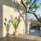 Pink stained glass tulip bouquet 3D flower stems held in hands as Mother's Day gift forever floral art casting colored shadows spring home decor handmade by LuzyGlassArt.