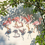 Pink stained glass flamingo suncatcher hanging in window casting vibrant colored shadows tropical beach house decor handmade gift for mom by LuzyGlassArt.